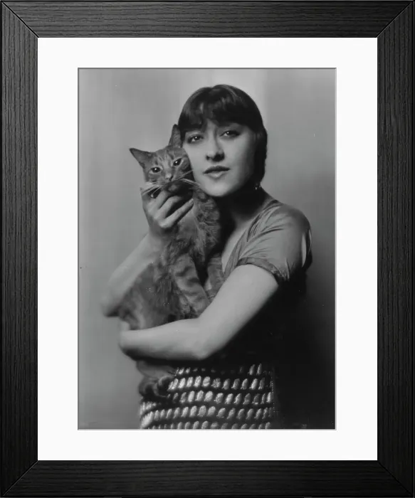 Framed Print : Dolly sister, with Buzzer the cat, portrait photograph, 1916. Creator: Arnold Genthe