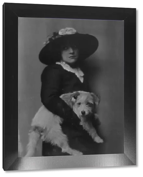 Taylor, Laurette, Miss, with dog, portrait photograph, 1913. Creator: Arnold Genthe