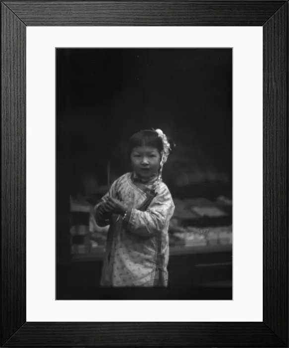 Framed Print : Young girl walking down the street, looking into the camera, Chinatown, San Francisco, c1896-c1906. Creator: Arnold Genthe Framed Print : Young girl walking down the street, looking into the camera, Chinatown, San Francisco, c1896-c1906. Creator: Arnold Genthe