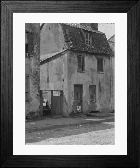 Framed Print : Boy sitting in the doorway of a two-story building, [17 Chalmers Street], Charleston... c1920-c1926 Creator: Arnold Genthe