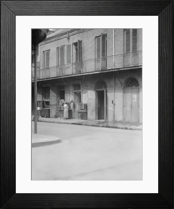 Framed Print : People standing by the doorway of a furniture shop in the French Quarter, New Orleans, c1920-1926. Creator: Arnold Genthe Framed Print : People standing by the doorway of a furniture shop in the French Quarter, New Orleans, c1920-1926. Creator: Arnold Genthe