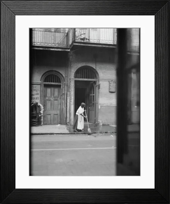 Framed Print : View from across street of a woman cleaning the sidewalk, New Orleans, between 1920 and 1926. Creator: Arnold Genthe Framed Print : View from across street of a woman cleaning the sidewalk, New Orleans, between 1920 and 1926. Creator: Arnold Genthe