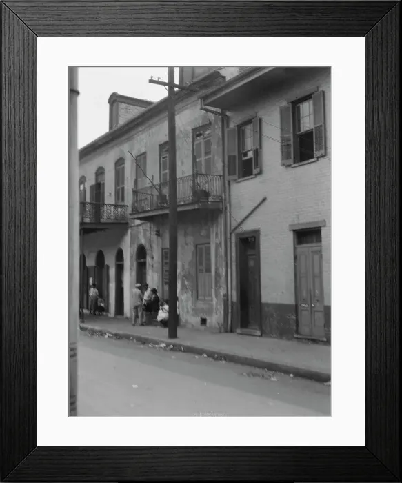 Framed Print : View from across street of four people talking in the French Quarter, New Orleans, c1920-1926. Creator: Arnold Genthe Framed Print : View from across street of four people talking in the French Quarter, New Orleans, c1920-1926. Creator: Arnold Genthe