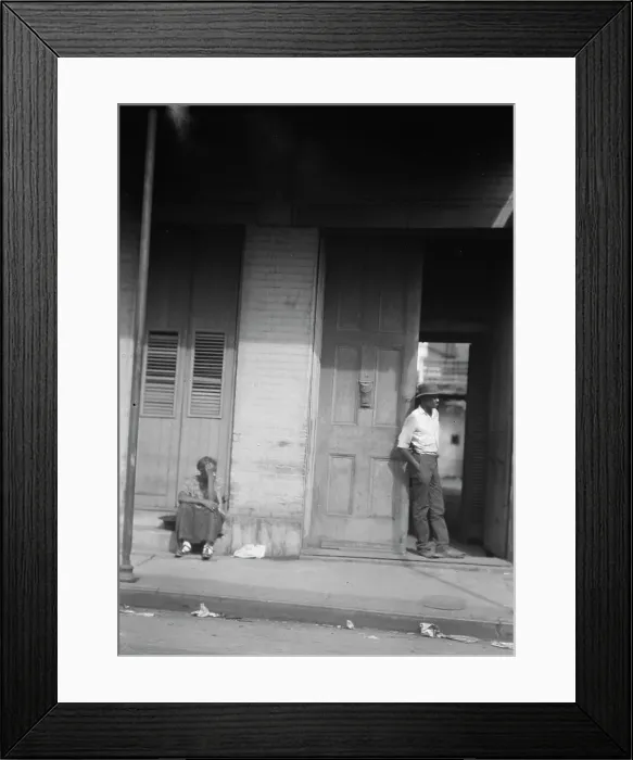 Framed Print : Woman sitting on steps and man standing in a doorway, New Orleans, between 1920 and 1926. Creator: Arnold Genthe Framed Print : Woman sitting on steps and man standing in a doorway, New Orleans, between 1920 and 1926. Creator: Arnold Genthe
