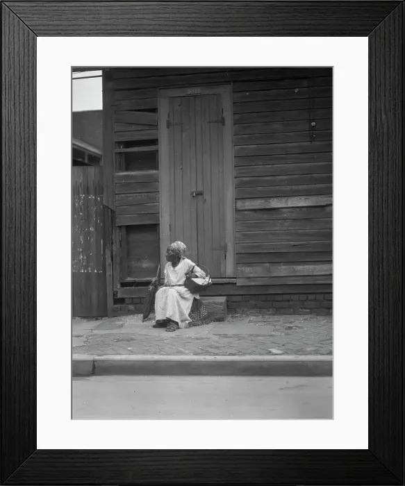 Framed Print : Woman sitting on steps holding a basket, New Orleans, between 1920 and 1926. Creator: Arnold Genthe Framed Print : Woman sitting on steps holding a basket, New Orleans, between 1920 and 1926. Creator: Arnold Genthe