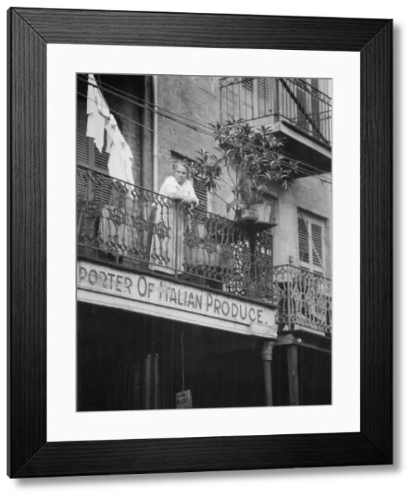 Framed Print : Woman leaning on a balcony, New Orleans, between 1920 and 1926. Creator: Arnold Genthe Framed Print : Woman leaning on a balcony, New Orleans, between 1920 and 1926. Creator: Arnold Genthe