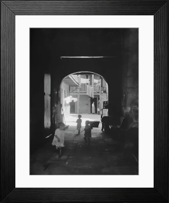 Framed Print : Children playing in an arched passageway, New Orleans, between 1920 and 1926. Creator: Arnold Genthe Framed Print : Children playing in an arched passageway, New Orleans, between 1920 and 1926. Creator: Arnold Genthe
