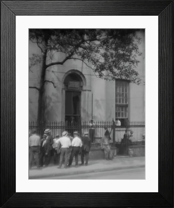 Framed Print : Men standing or sitting in front of the former Bank of Louisiana, 334 Royal Street... c1920-1926. Creator: Arnold Genthe Framed Print : Men standing or sitting in front of the former Bank of Louisiana, 334 Royal Street... c1920-1926. Creator: Arnold Genthe