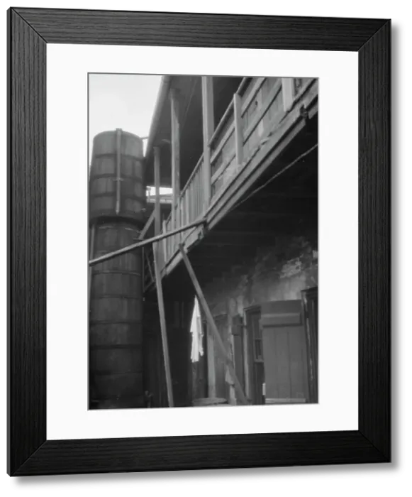 Framed Print : Courtyard with cistern, New Orleans, between 1920 and 1926. Creator: Arnold Genthe Framed Print : Courtyard with cistern, New Orleans, between 1920 and 1926. Creator: Arnold Genthe