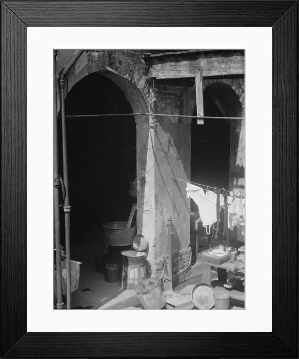 Framed Print : Courtyard with hanging laundry and laundry equipment, New Orleans, between 1920 and 1926. Creator: Arnold Genthe Framed Print : Courtyard with hanging laundry and laundry equipment, New Orleans, between 1920 and 1926. Creator: Arnold Genthe