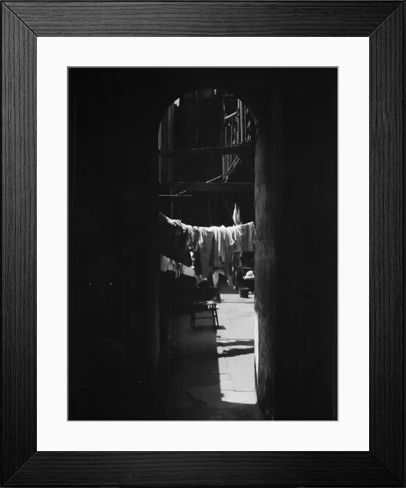 Framed Print : Courtyard with hanging laundry, New Orleans, between 1920 and 1926. Creator: Arnold Genthe Framed Print : Courtyard with hanging laundry, New Orleans, between 1920 and 1926. Creator: Arnold Genthe