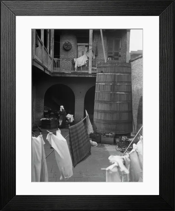 Framed Print : Courtyard with hanging laundry, New Orleans, between 1920 and 1926. Creator: Arnold Genthe Framed Print : Courtyard with hanging laundry, New Orleans, between 1920 and 1926. Creator: Arnold Genthe