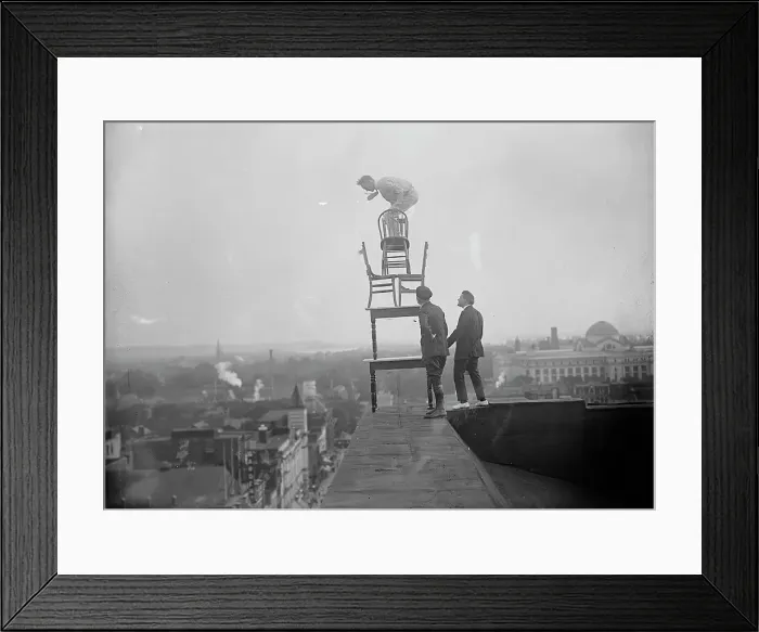 Framed Print : J. Reynolds, Performing Acrobatic And Balancing Acts On High Cornice Above 9th Street, N.W. 1917. Creator: Harris & Ewing. J. Reynolds, Performing Acrobatic And Balancing Acts On High Cornice Above 9th Street, N.W. 1917 Framed Print : J. Reynolds, Performing Acrobatic And Balancing Acts On High Cornice Above 9th Street, N.W. 1917. Creator: Harris & Ewing. J. Reynolds, Performing Acrobatic And Balancing Acts On High Cornice Above 9th Street, N.W. 1917