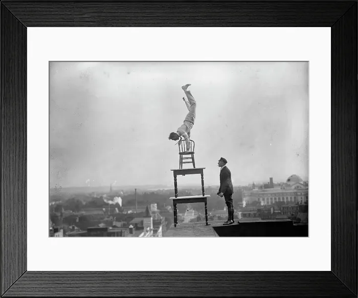 Framed Print : J. Reynolds, Performing Acrobatic And Balancing Acts On High Cornice Above 9th Street, N.W. 1917. Creator: Harris & Ewing. J. Reynolds, Performing Acrobatic And Balancing Acts On High Cornice Above 9th Street, N.W. 1917 Framed Print : J. Reynolds, Performing Acrobatic And Balancing Acts On High Cornice Above 9th Street, N.W. 1917. Creator: Harris & Ewing. J. Reynolds, Performing Acrobatic And Balancing Acts On High Cornice Above 9th Street, N.W. 1917