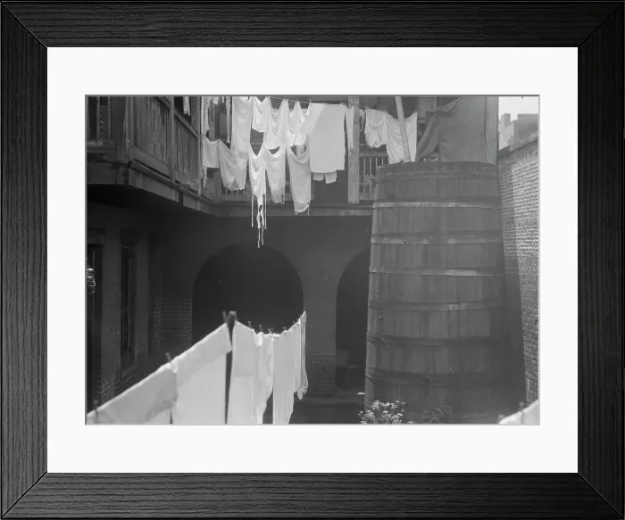 Framed Print : Courtyard with cistern and hanging laundry, New Orleans, between 1920 and 1926. Creator: Arnold Genthe Framed Print : Courtyard with cistern and hanging laundry, New Orleans, between 1920 and 1926. Creator: Arnold Genthe