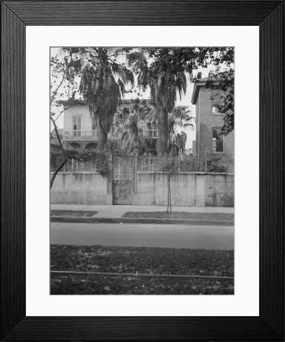 Framed Print : View from across street of two-story house behind wall, New Orleans, between 1920 and 1926. Creator: Arnold Genthe
