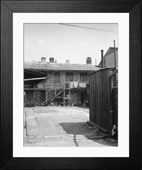 Framed Print : View of two-story dwellings with laundry hanging over balcony railing, New Orleans, c1920-1926. Creator: Arnold Genthe Framed Print : View of two-story dwellings with laundry hanging over balcony railing, New Orleans, c1920-1926. Creator: Arnold Genthe