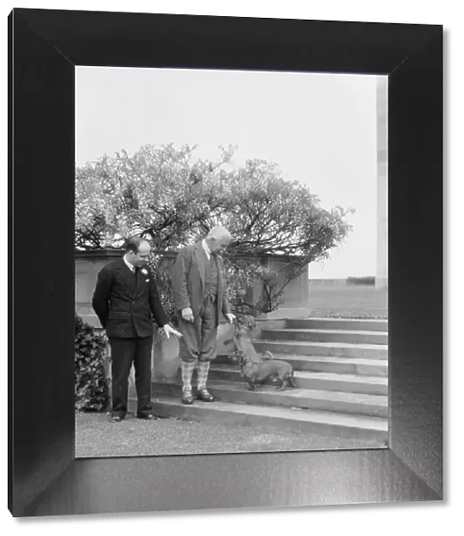 Kahn, Otto H. Mr. and unidentified man, with dog, standing outdoors, 1928 Creator: Arnold Genthe