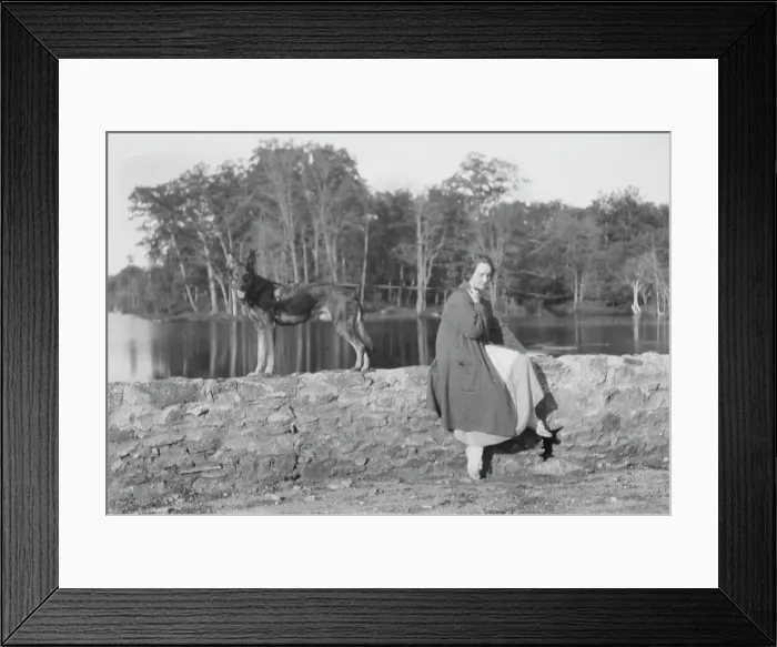 Framed Print : Mower, Margaret, Miss, with dog, seated outdoors, not before 1916. Creator: Arnold Genthe Framed Print : Mower, Margaret, Miss, with dog, seated outdoors, not before 1916. Creator: Arnold Genthe