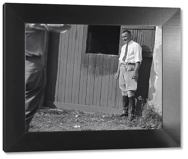 Rothbart, Albert, Mr. grounds, with unidentified man standing by a stable door, c1920-1935. Creator: Arnold Genthe