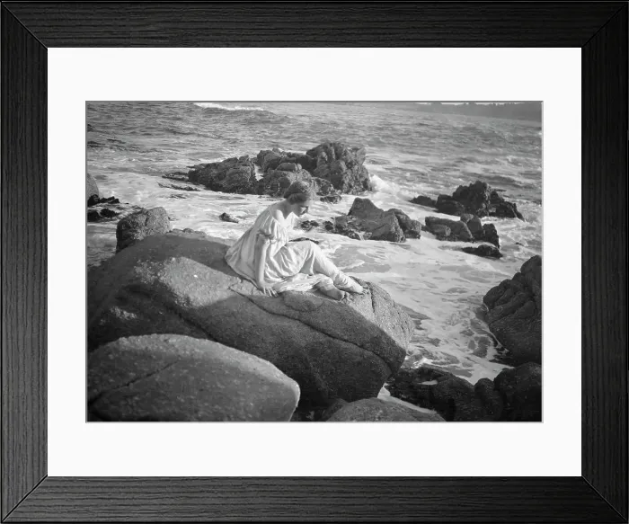 Framed Print : Wilson, Helen, Mrs. seated on rocks at the beach, between 1906 and 1928. Creator: Arnold Genthe Framed Print : Wilson, Helen, Mrs. seated on rocks at the beach, between 1906 and 1928. Creator: Arnold Genthe