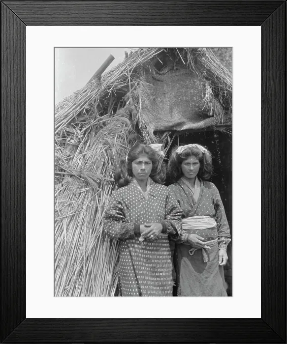 Framed Print : Two Ainu women standing at the entrance of a hut, 1908. Creator: Arnold Genthe Framed Print : Two Ainu women standing at the entrance of a hut, 1908. Creator: Arnold Genthe