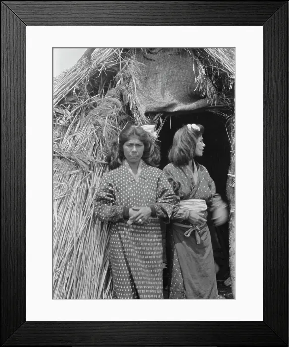 Framed Print : Two Ainu women standing outside the entrance of a hut, 1908. Creator: Arnold Genthe Framed Print : Two Ainu women standing outside the entrance of a hut, 1908. Creator: Arnold Genthe