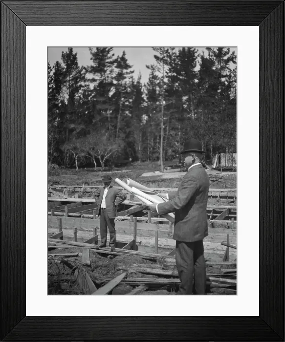 Framed Print : Unidentified man at a construction site studying building plans, between 1896 and 1942. Creator: Arnold Genthe Framed Print : Unidentified man at a construction site studying building plans, between 1896 and 1942. Creator: Arnold Genthe