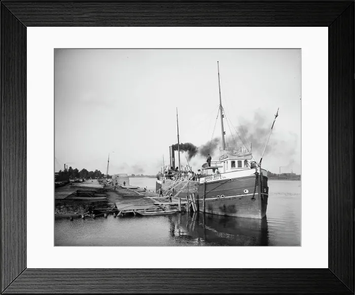 Framed Print : Unloading lumber, Saginaw, Mich. between 1900 and 1910. Creator: Unknown