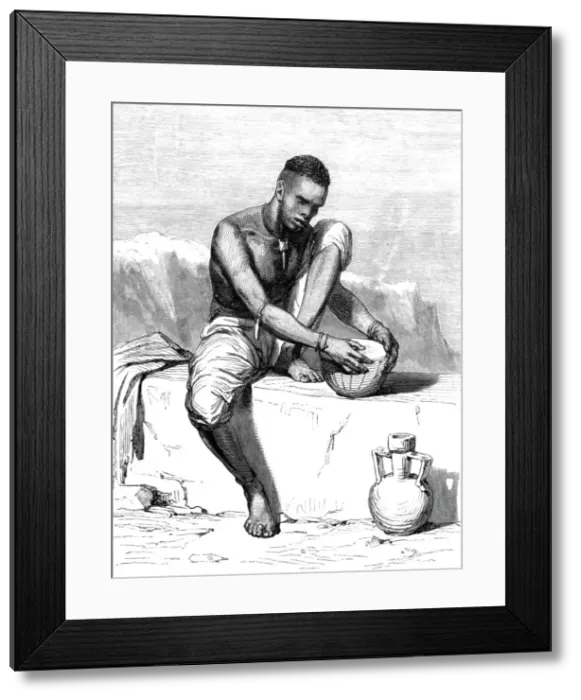 Framed Print : Native of the Dinka tribe, white Nile, mending his drum; The Nile Valley above Khartum, 1875. Creator: Unknown Framed Print : Native of the Dinka tribe, white Nile, mending his drum; The Nile Valley above Khartum, 1875. Creator: Unknown