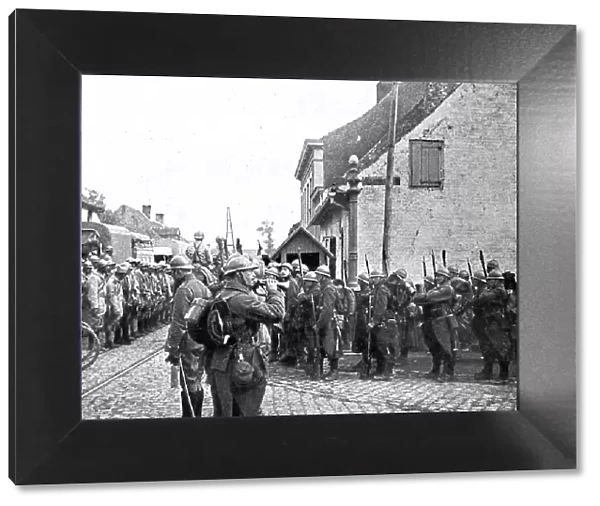 Operations in Flanders; Belgian troops pay honour to the flag of a French regiment... 1917. Creator: Unknown