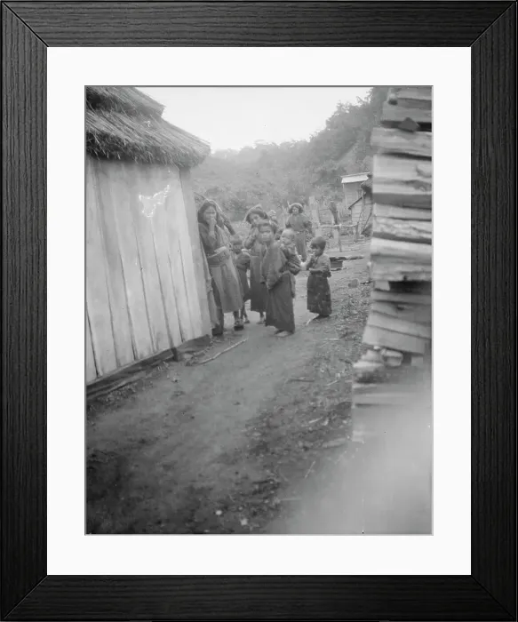 Framed Print : Group of Ainu children standing in a passageway between huts, 1908. Creator: Arnold Genthe Framed Print : Group of Ainu children standing in a passageway between huts, 1908. Creator: Arnold Genthe