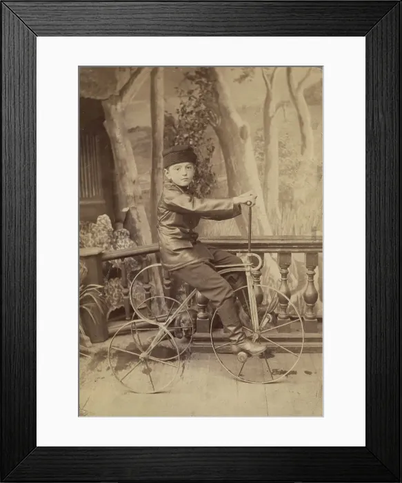 Framed Print : A boy on a bicycle in a photo studio, 1880. Creator: Unknown Framed Print : A boy on a bicycle in a photo studio, 1880. Creator: Unknown