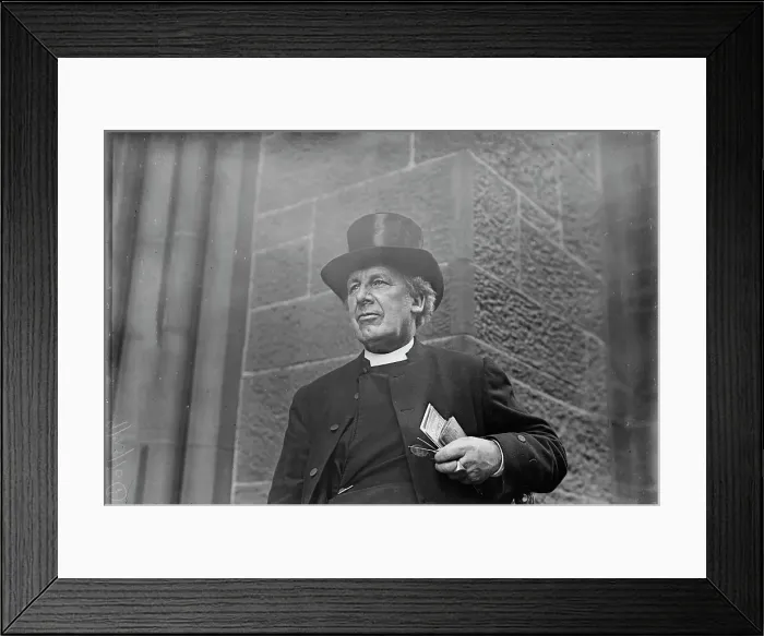 Framed Print : Bishop of Salisbury holding glasses and train schedule, 1910. Creator: Bain News Service