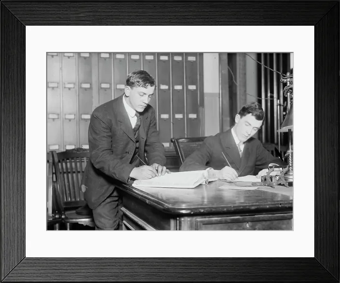 Framed Print : Two new citizens sign naturalizaton papers in judge's chambers, 1910. Creator: Bain News Service Framed Print : Two new citizens sign naturalizaton papers in judge's chambers, 1910. Creator: Bain News Service