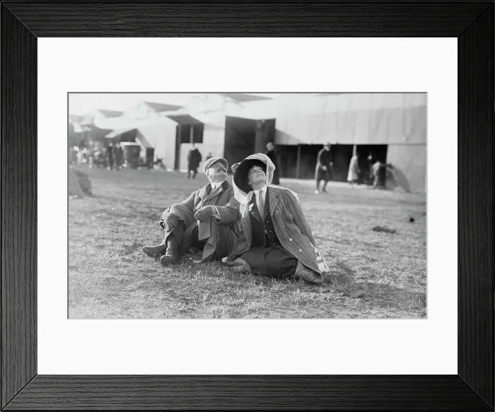 Framed Print : Mrs. Payne Whitney with unidentified gentleman seated on flying field of aviation meet, 1910. Creator: Bain News Service Framed Print : Mrs. Payne Whitney with unidentified gentleman seated on flying field of aviation meet, 1910. Creator: Bain News Service