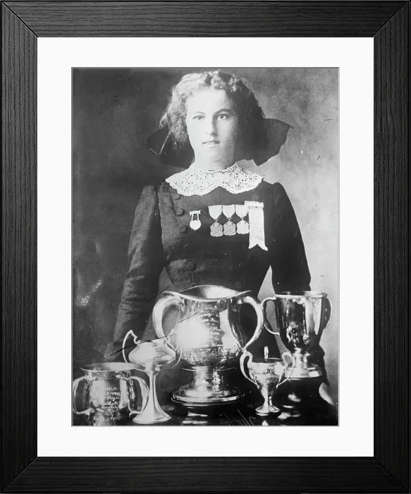 Framed Print : Alsie Aykroyd in front of her trophies, 1910. Creator: Bain News Service