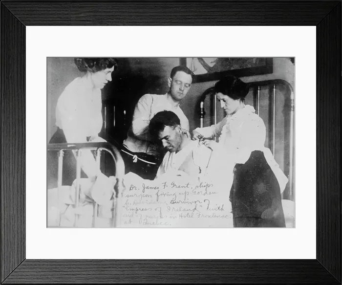 Framed Print : Dr. James F. Grant, ship's surgeon, fixing up Gordon G. Davidson, survivor of EMPRESS OF... 1914. Creator: Bain News Service Framed Print : Dr. James F. Grant, ship's surgeon, fixing up Gordon G. Davidson, survivor of EMPRESS OF... 1914. Creator: Bain News Service