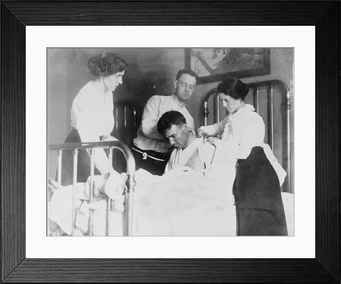Framed Print : Dr. James F Grant, ship's surgeon, fixing up Gordan G Davidson, survivor of EMPRESS OF... 1914. Creator: Bain News Service Framed Print : Dr. James F Grant, ship's surgeon, fixing up Gordan G Davidson, survivor of EMPRESS OF... 1914. Creator: Bain News Service