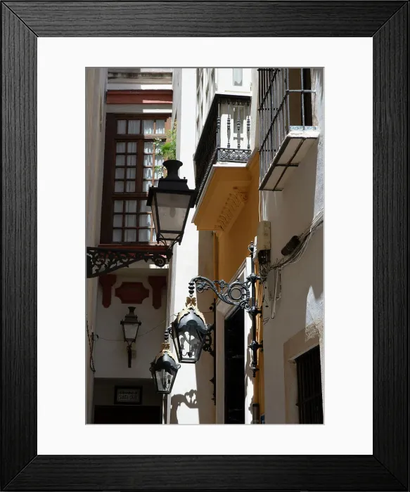 Framed Print : Narrow street with old lamps and balconies in the pedestrian area of Seville, Spain, 2023. Creator: Ethel Davies Framed Print : Narrow street with old lamps and balconies in the pedestrian area of Seville, Spain, 2023. Creator: Ethel Davies