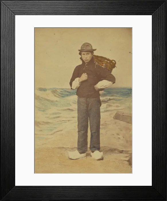 Framed Print : Dutch boy in front of painted sea background, 1865-1875. Creator: Willem Frederik Vinkenbos