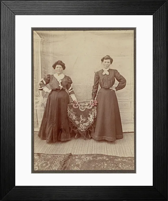 Framed Print : Two women standing at a table holding flowers, about 1875. Creator: Unknown Framed Print : Two women standing at a table holding flowers, about 1875. Creator: Unknown