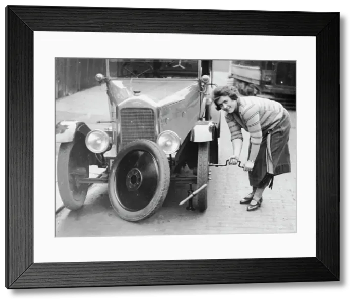 Framed Print : Ivy Cummings changing a tyre on a 1925 Singer 10 / 26, London, c1925 Framed Print : Ivy Cummings changing a tyre on a 1925 Singer 10 / 26, London, c1925