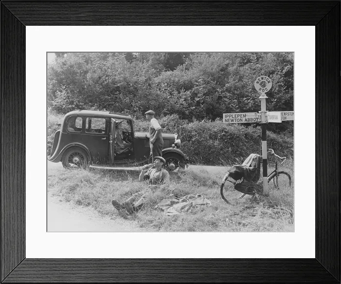 Framed Print : People relaxing by a signpost with a 1935 Standard 10 hp car, Devon, (c1935?) Framed Print : People relaxing by a signpost with a 1935 Standard 10 hp car, Devon, (c1935?)