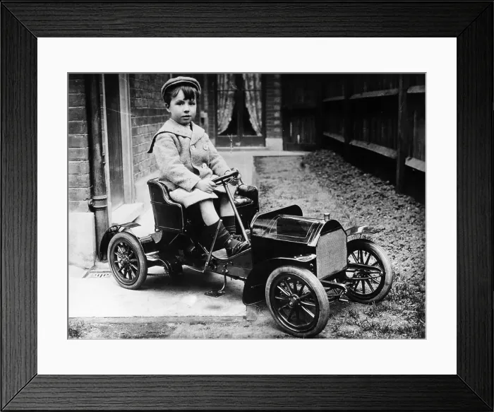 Framed Print : Boy in 1908 Mercedes 28 / 32 hp pedal car, c1908