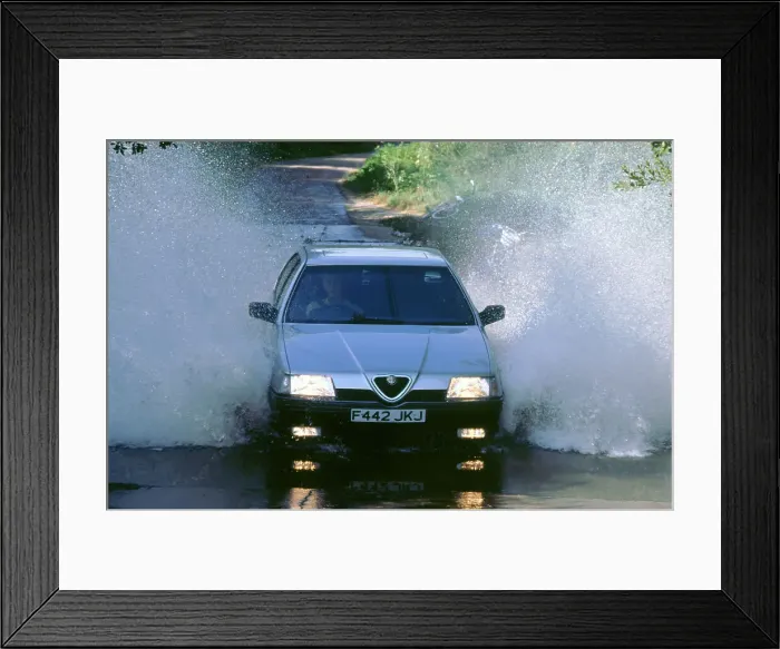 Framed Print : 1989 Alfa Romeo 164 driving through a ford Framed Print : 1989 Alfa Romeo 164 driving through a ford