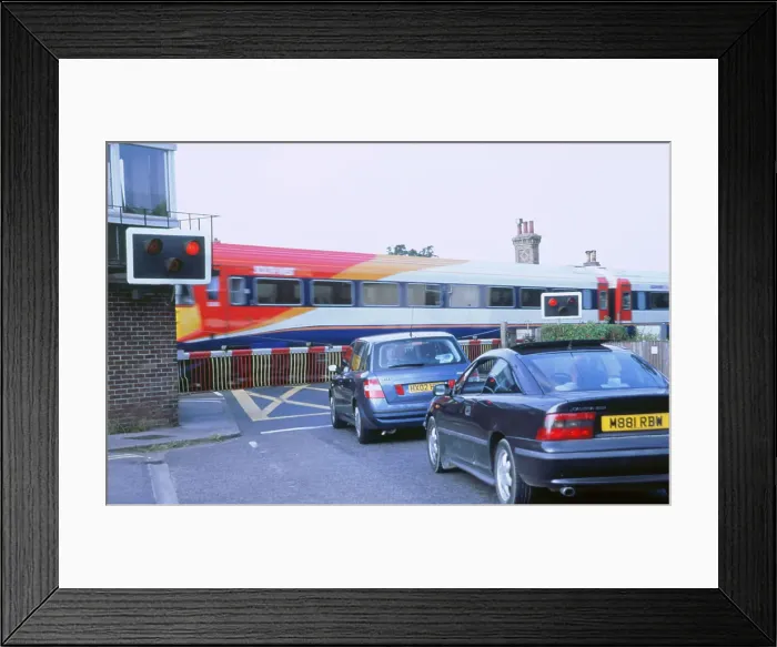 Framed Print : Traffic queue at level crossing in Brockenhurst, Hampshire Framed Print : Traffic queue at level crossing in Brockenhurst, Hampshire