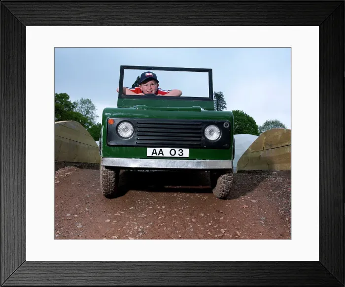Framed Print : Children driving a toy Land Rover Framed Print : Children driving a toy Land Rover