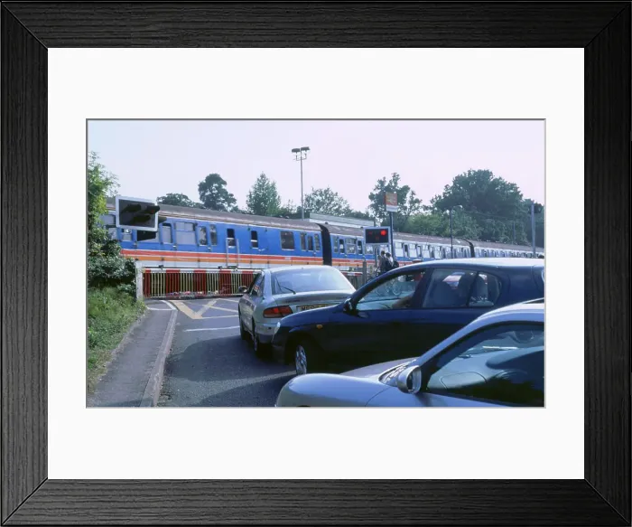 Framed Print : Traffic queue at level crossing in Brockenhurst, Hampshire Framed Print : Traffic queue at level crossing in Brockenhurst, Hampshire