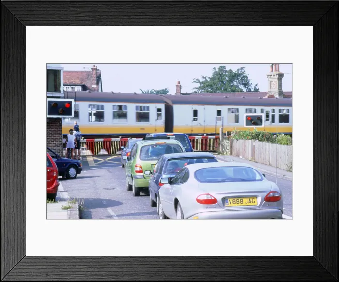 Framed Print : Traffic queue at level crossing in Brockenhurst, Hampshire Framed Print : Traffic queue at level crossing in Brockenhurst, Hampshire